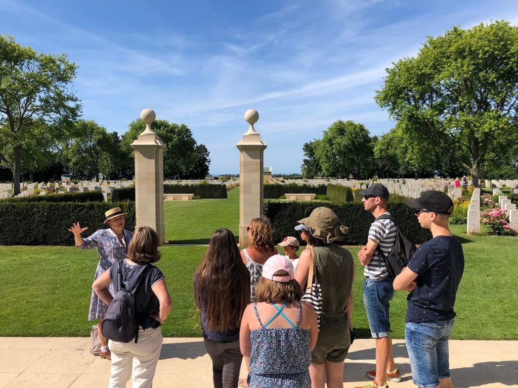 Corine Vervaeke, guide conférencière, raconte à un groupe de visiteurs le cimetière canadien.