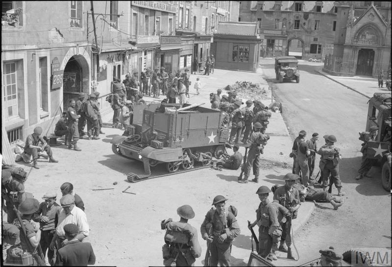 street scene in douvres as troops take a rest on their way to the frontline taken by captain malindine 13 june 1944 iwm b 5510a