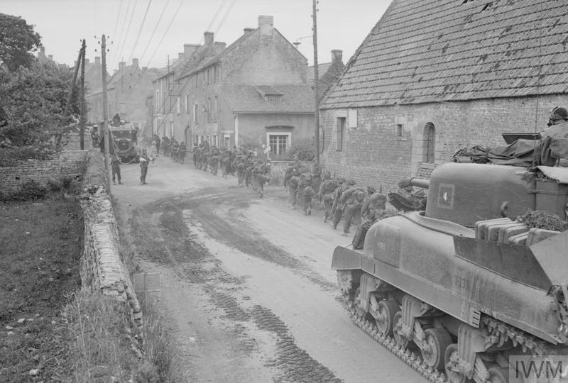 troops and equipment continue to come ashore on the beaches of normandy and proceed indland through the french villages taken by capt malindine recd 12 june 1944 iwm b 5386