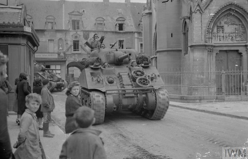 sherman tanks driving through douvres la delivrande 8 june 1944 lt handford iwmb5267